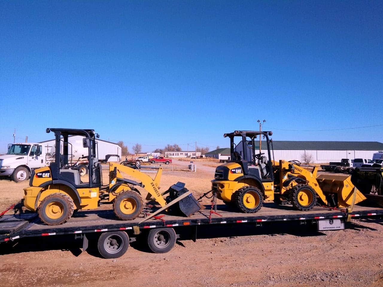 Two CAT tractors loaded for transport