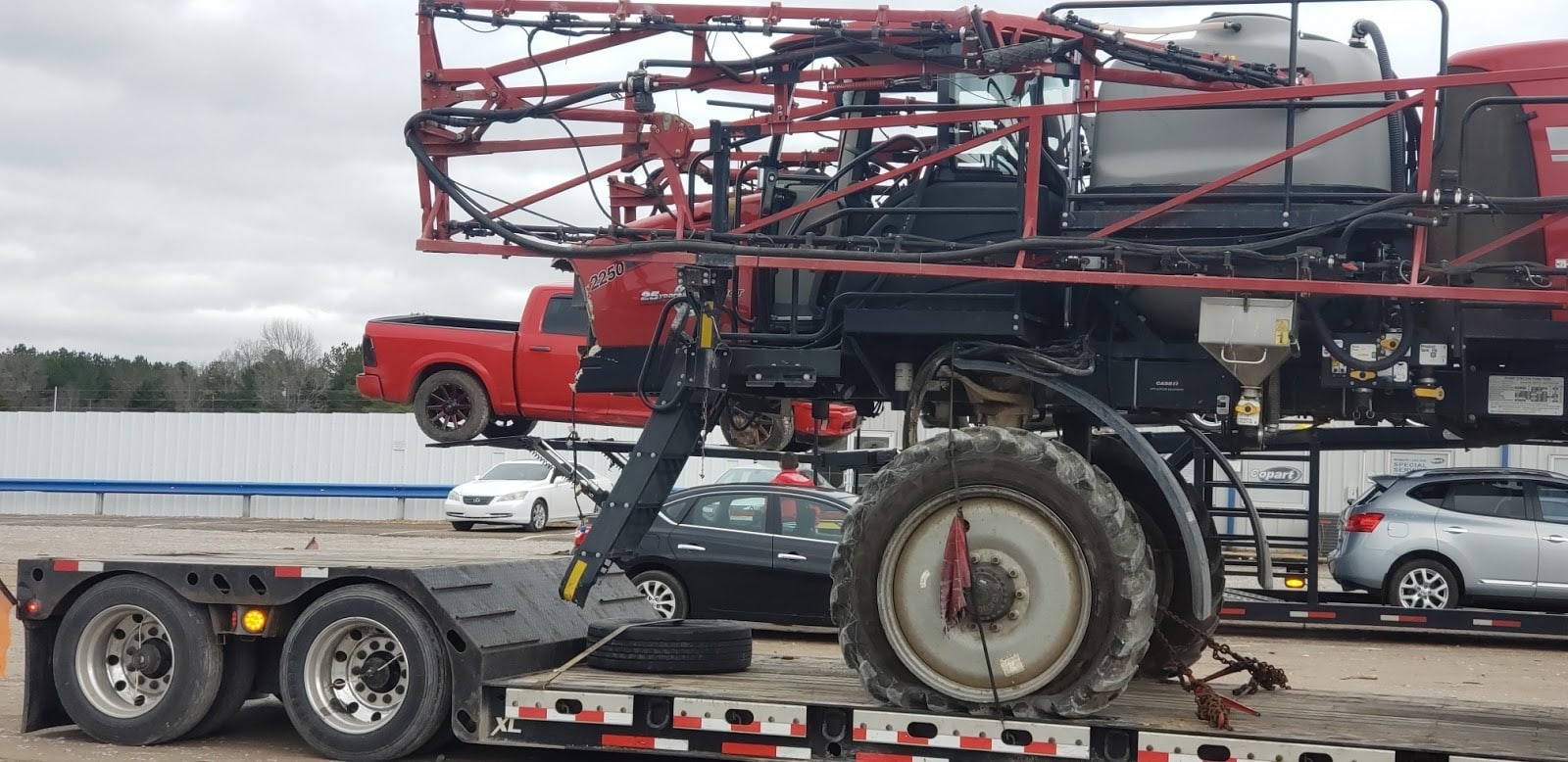 Transporting a 2017 Case 2250 Sprayer on a lowboy trailer