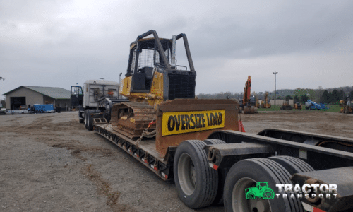John Deere 700 Crawler Dozer loaded for transport on a lowboy trailer