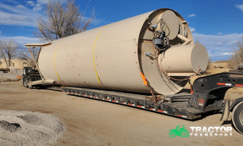 Silo tank prepared for transport on a lowboy trailer