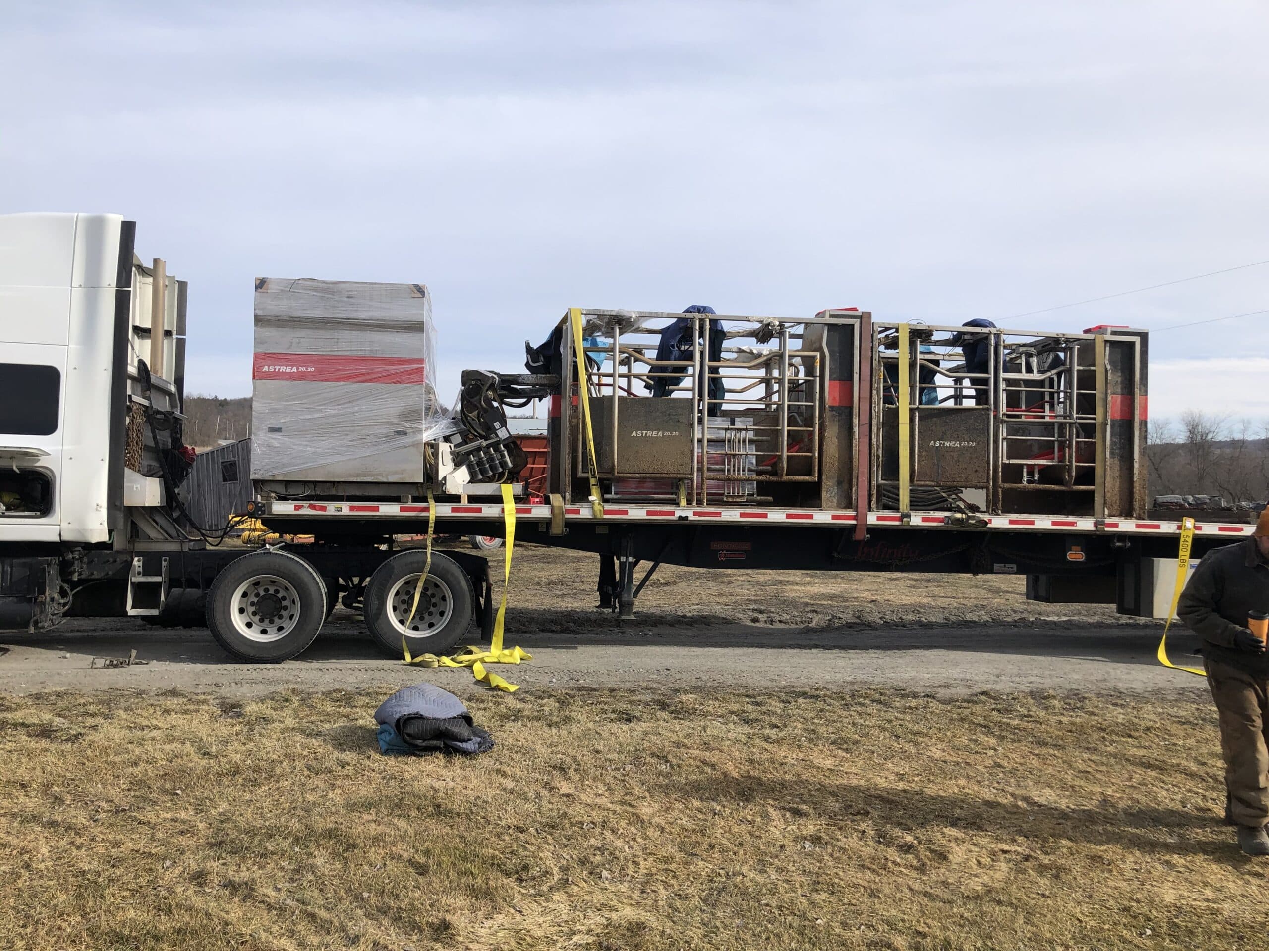 Milking system loaded for transport on a flatbed trailer