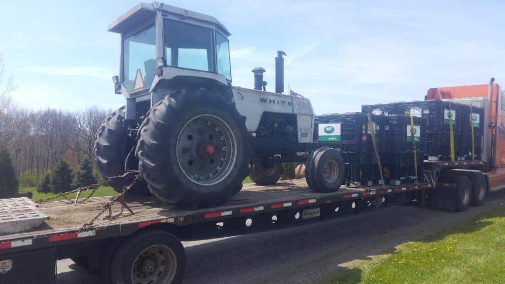 White Tractor loaded for transport