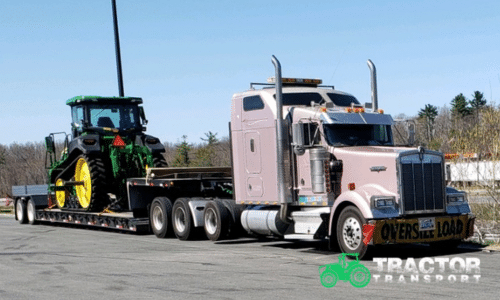Oversize John Deere Tractor loaded for transport on a lowboy trailer