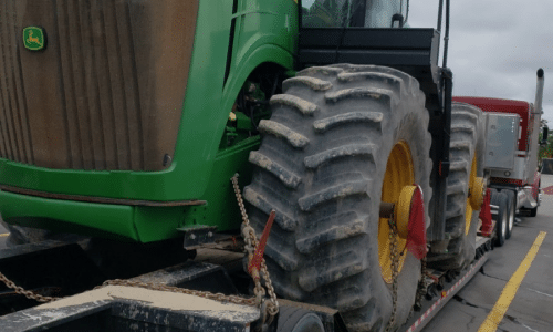John Deere 9560R Tractor loaded on a lowboy trailer for transport