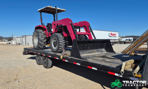 ed Massey Ferguson tractor with front loader loaded on flatbed trailer for transport by Tractor Transport