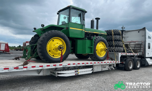 John Deere farm tractor secured on flatbed trailer for professional tractor transport service