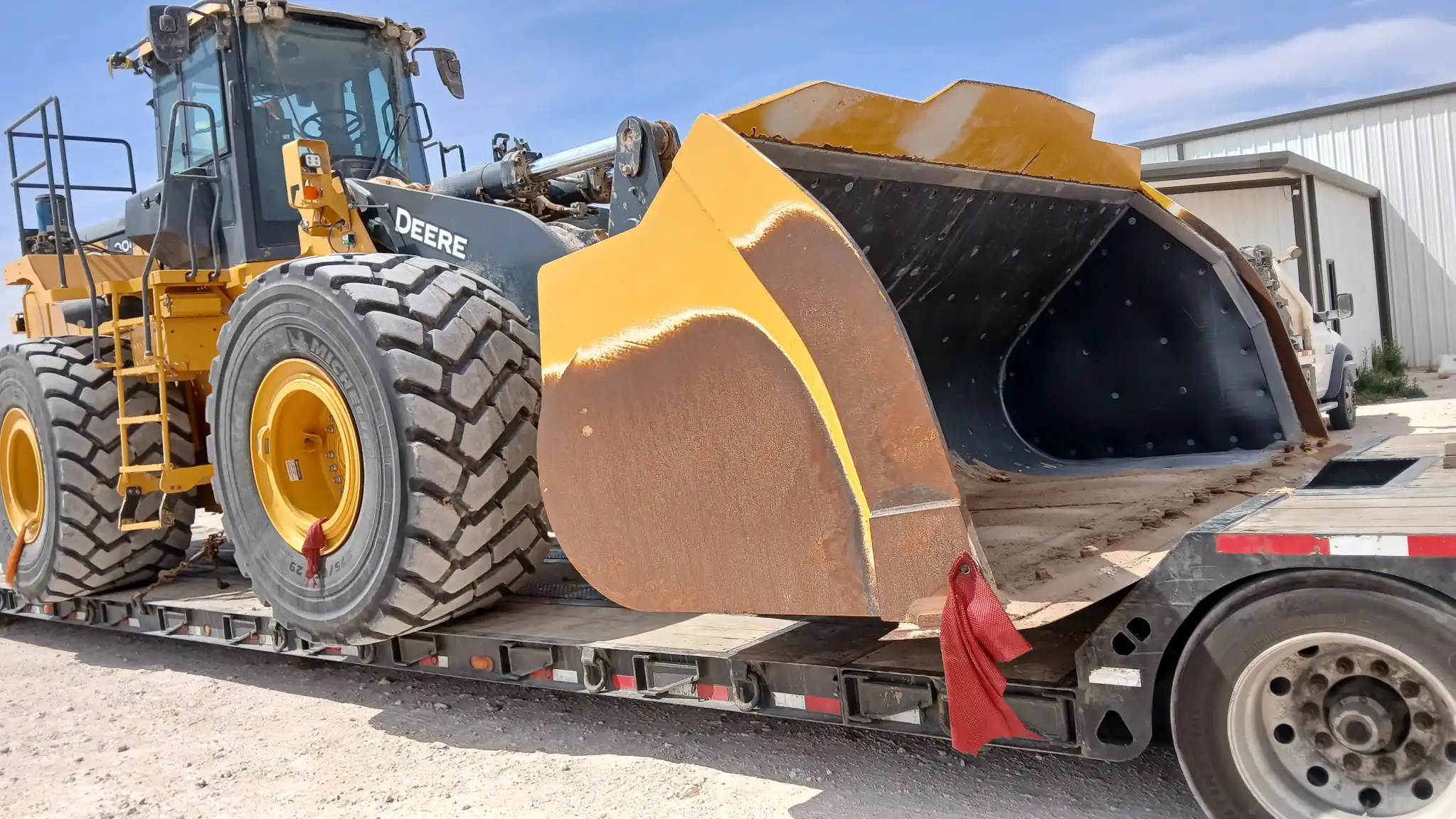 Wheel loader being transported on a step deck trailer